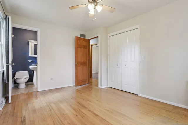 a view of a room with wooden floor and window