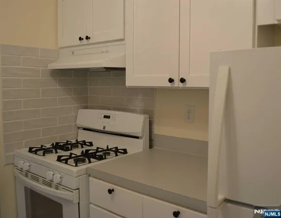 a kitchen with a stove and a refrigerator