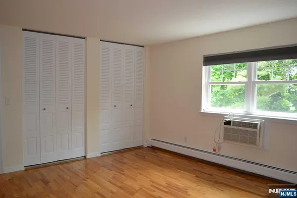 a view of a kitchen with wooden floor and a window