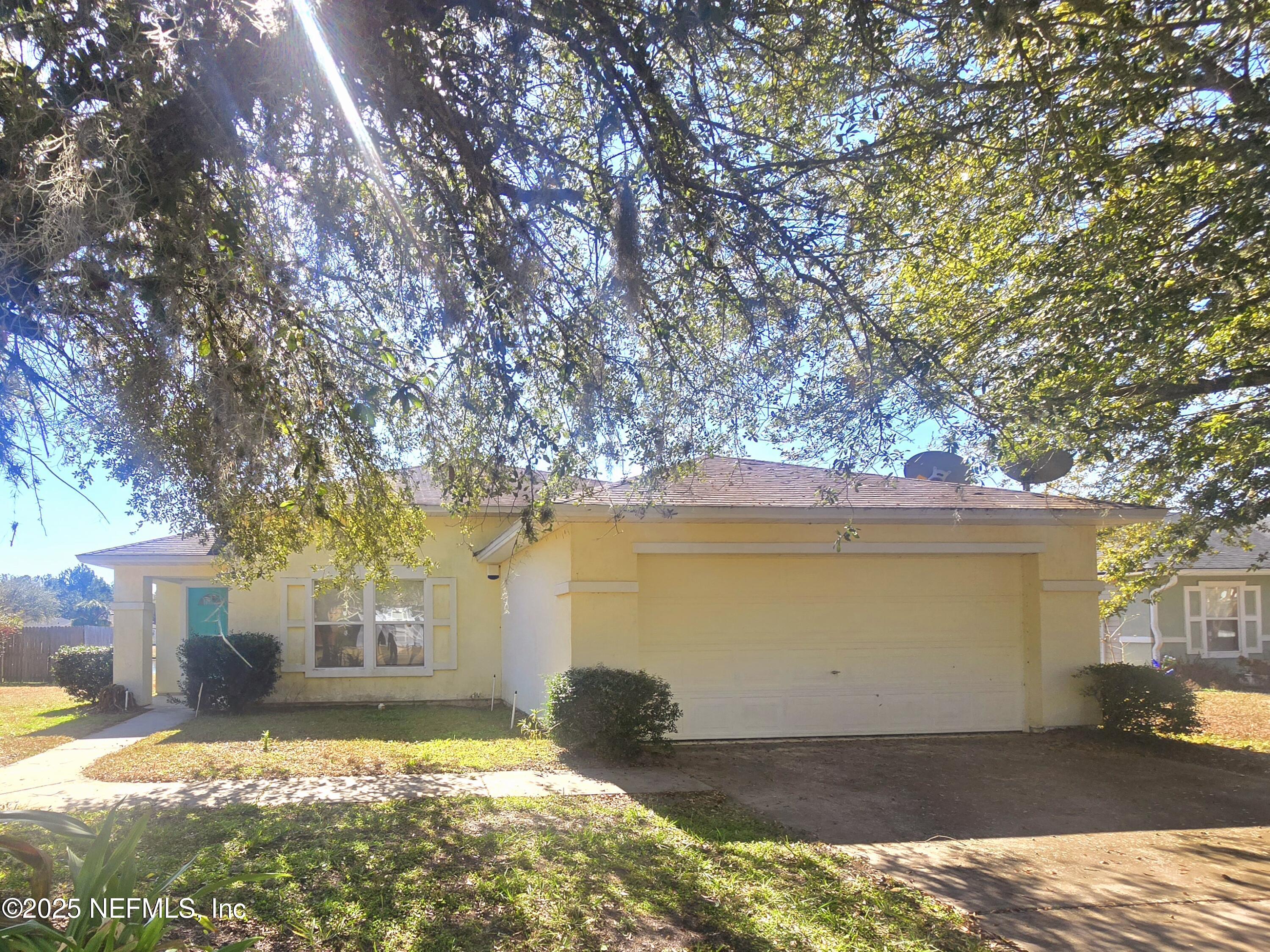 76264 Long Pond Loop Yulee, FL 32097 - Photo 1 of 15 a view of a house with backyard and sitting area