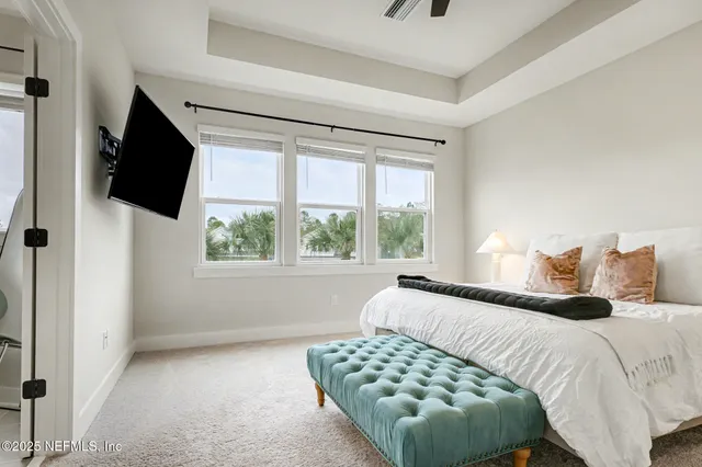 a bedroom with a bed and a flat tv screen