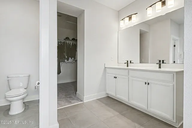 a spacious bathroom with a toilet sink and shower