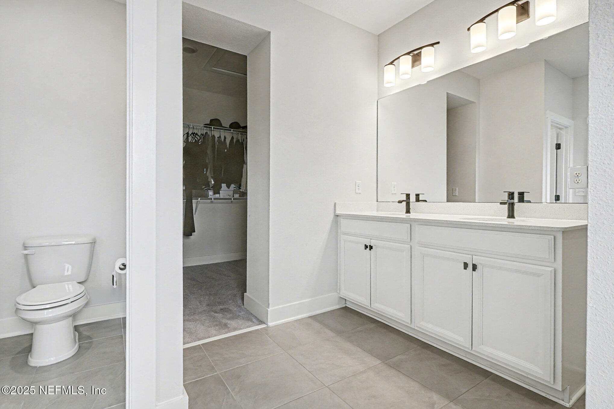 9858 Element Road Jacksonville, FL 32256 - Photo 13 of 19 a spacious bathroom with a toilet sink and shower