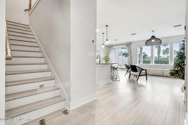 a view of a living room and entryway with wooden floor