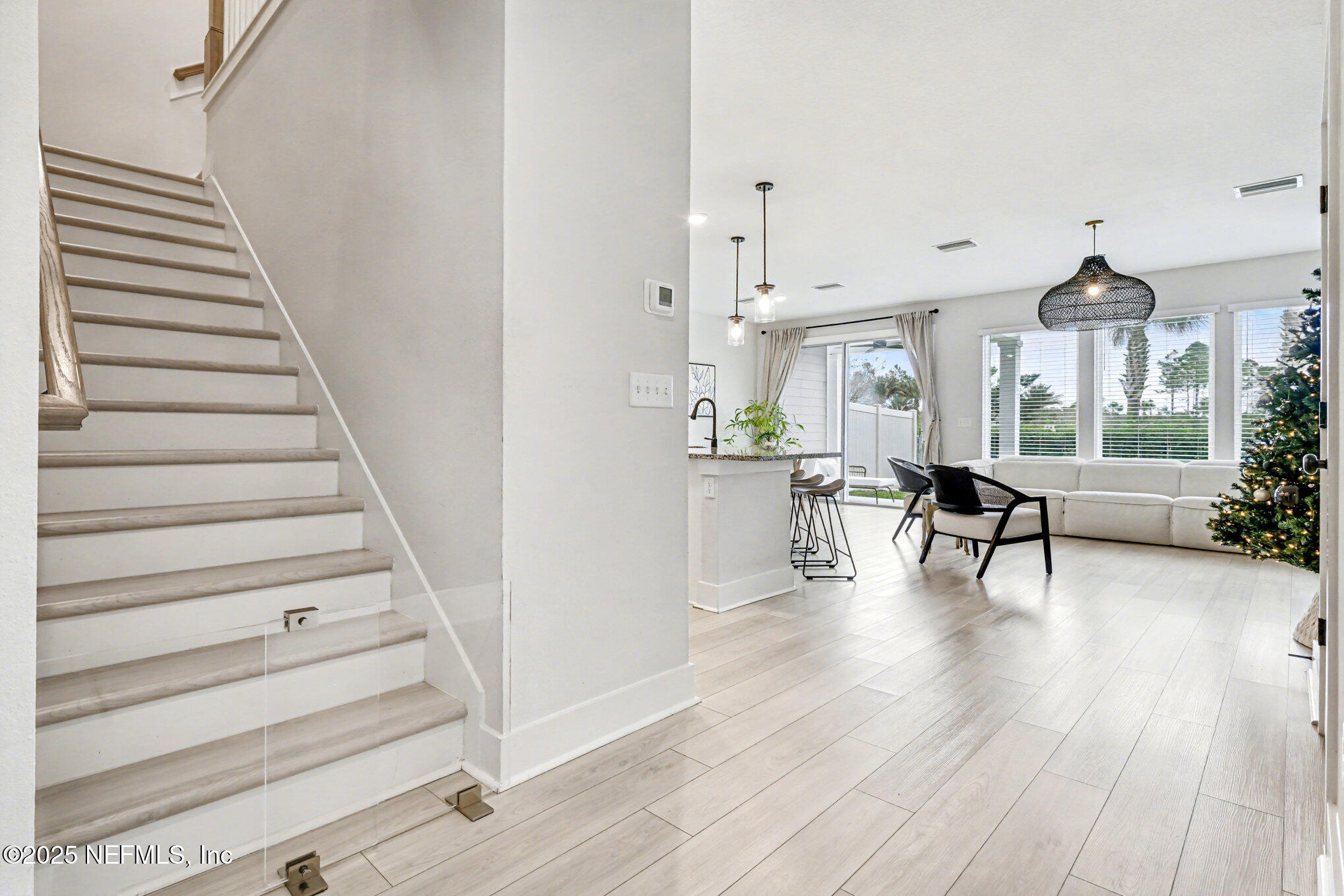 9858 Element Road Jacksonville, FL 32256 - Photo 14 of 19 a view of a living room and entryway with wooden floor