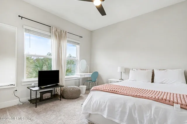 a bedroom with a bed and glass window