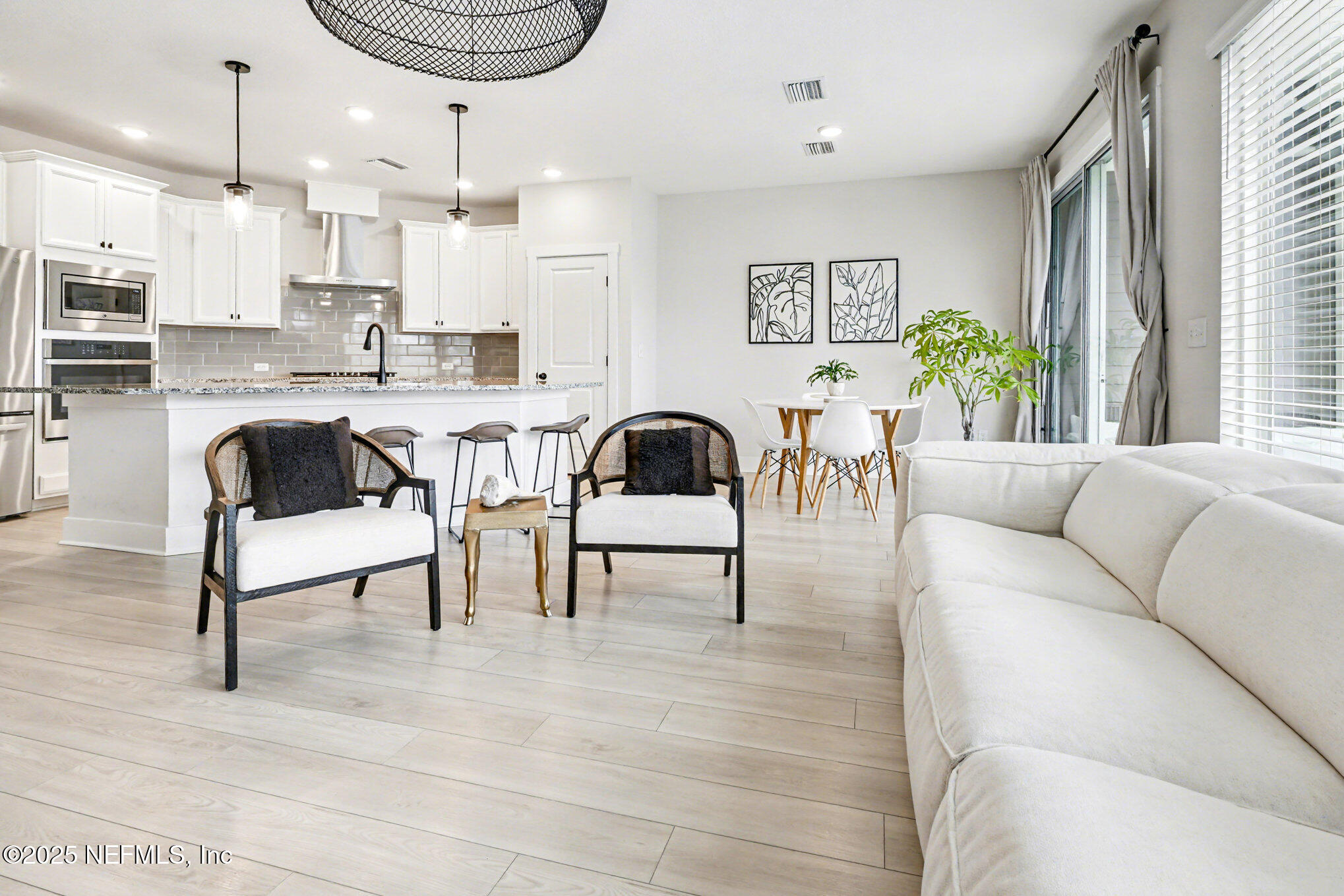 9858 Element Road Jacksonville, FL 32256 - Photo 5 of 19 a living room with furniture a rug and a kitchen