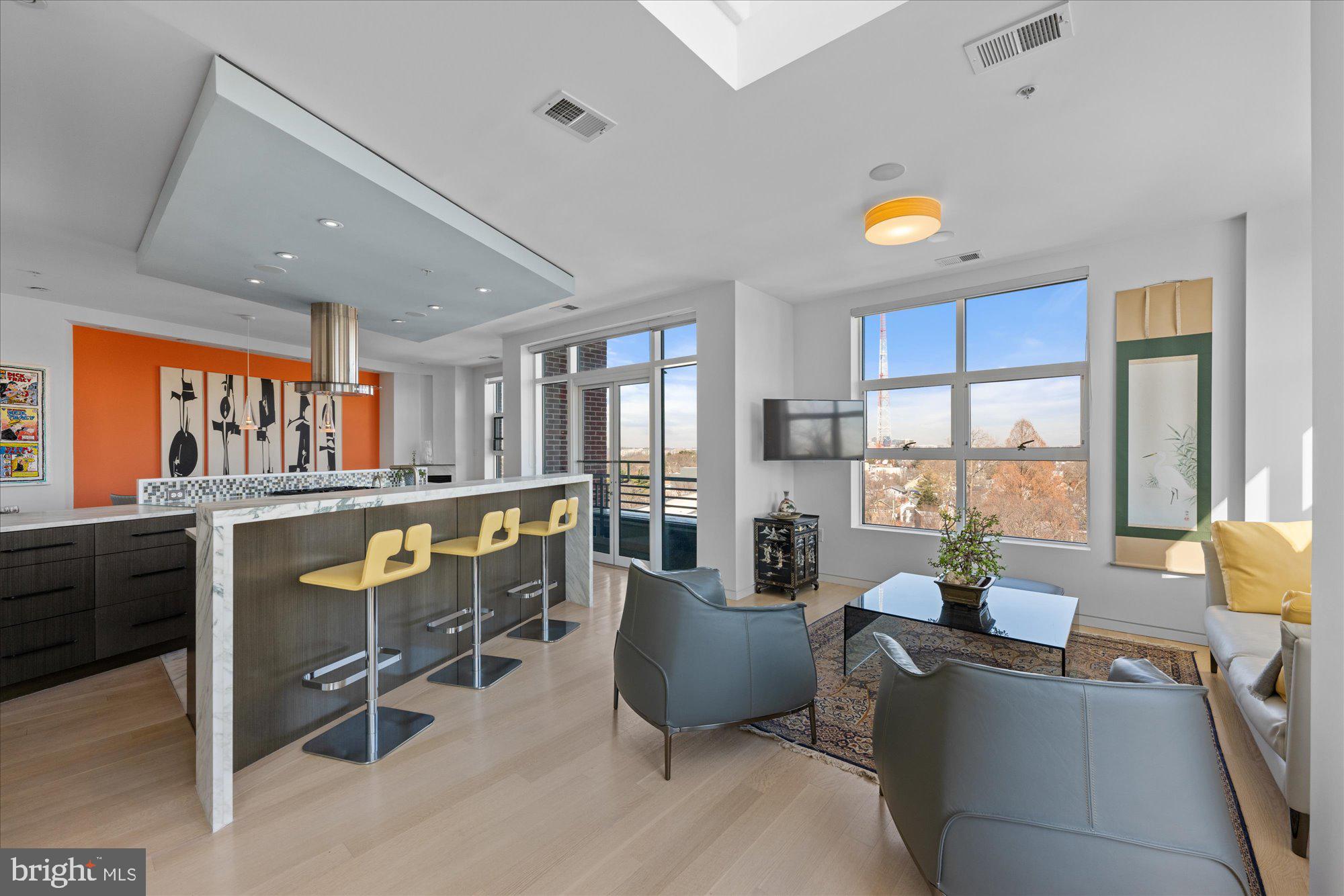 4750 41st Street Northwest, Unit 507 Washington, DC 20016 - Photo 16 of 55 a living room with furniture a flat screen tv and large windows