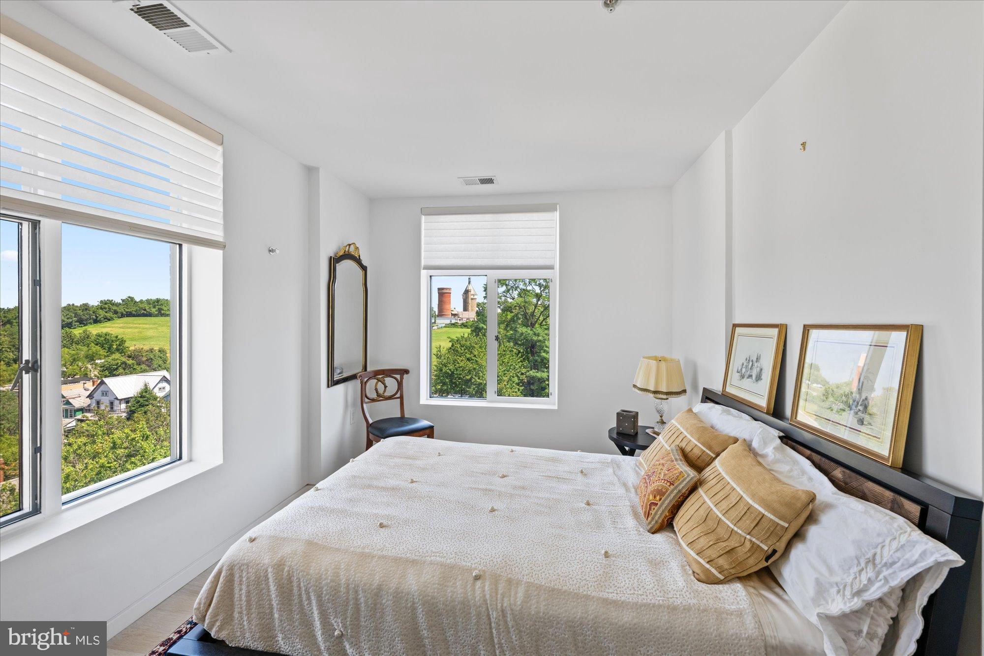 4750 41st Street Northwest, Unit 507 Washington, DC 20016 - Photo 34 of 55 a bedroom with a bed and a large window