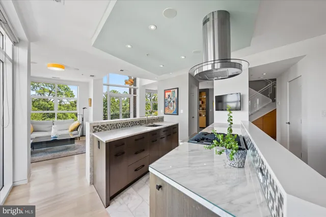 a kitchen with stainless steel appliances granite countertop a sink and a stove