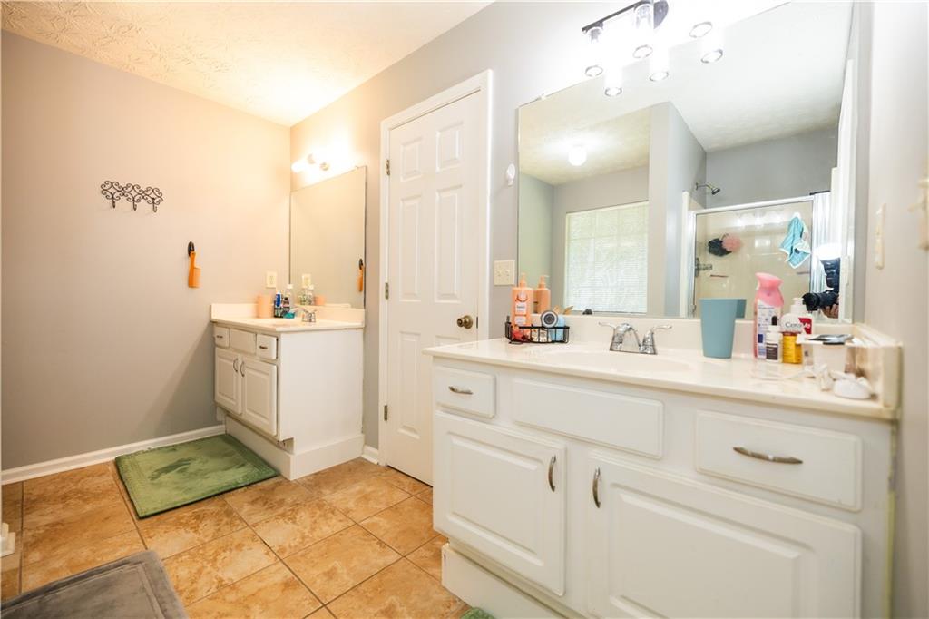 599 Rivulett Court Lawrenceville, GA 30043 - Photo 14 of 31 a bathroom with a sink and a mirror
