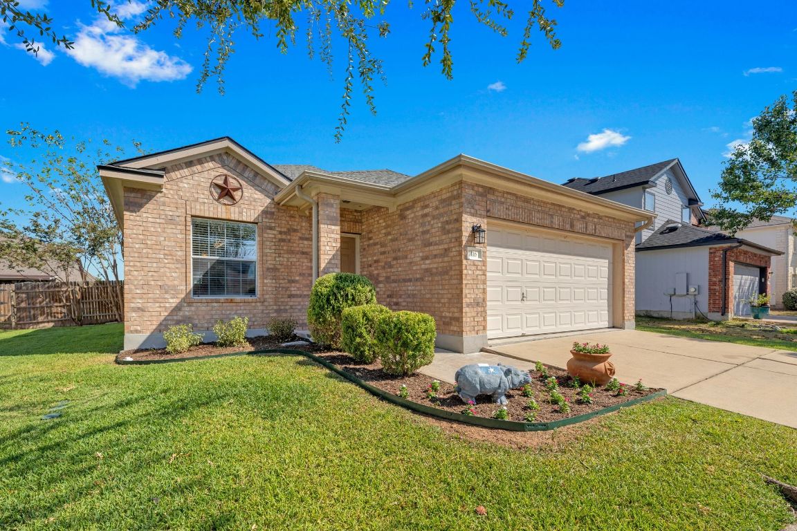 116 Almquist Street Hutto, TX 78634 - Photo 1 of 1 a front view of a house with a yard and garage