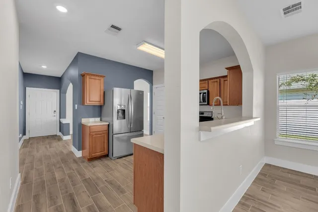 a kitchen with a sink cabinets and stainless steel appliances