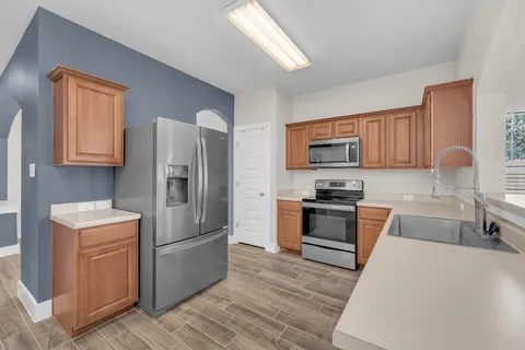 a kitchen with a sink stove and microwave
