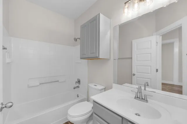 a view of an empty room with closet and window