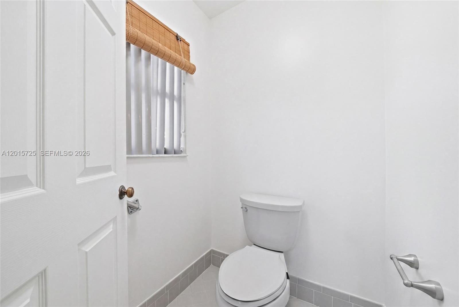 11008 Boca Woods Lane Boca Raton, FL 33428 - Photo 23 of 70 a white toilet sitting next to a shower