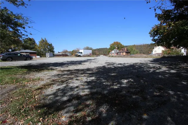 a view of a field of grass and trees