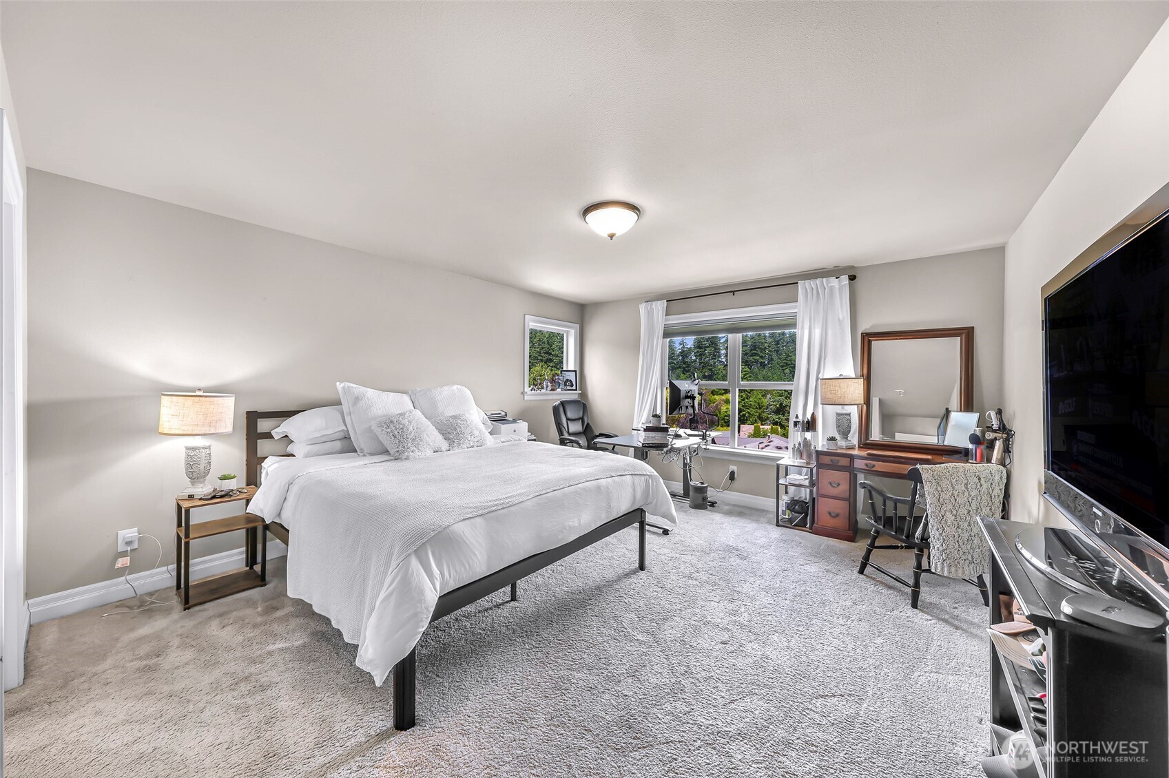 1301 Broad Street Bellingham, WA 98229 - Photo 29 of 40 a bedroom with a bed and a flat screen tv