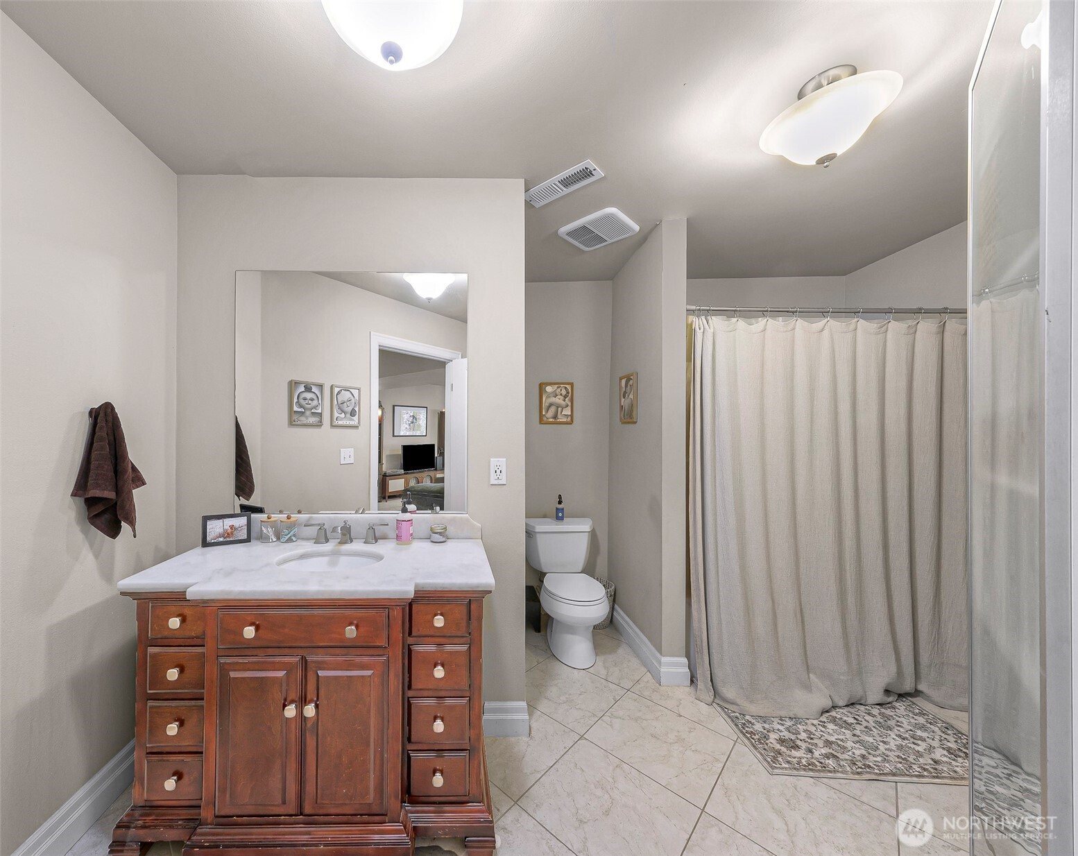 1301 Broad Street Bellingham, WA 98229 - Photo 37 of 40 a bathroom with a granite countertop sink a mirror and a toilet