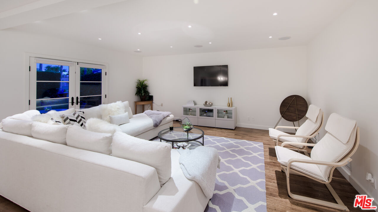 441 North Kings Road Los Angeles, CA 90048 - Photo 12 of 36 a living room with furniture and a flat screen tv