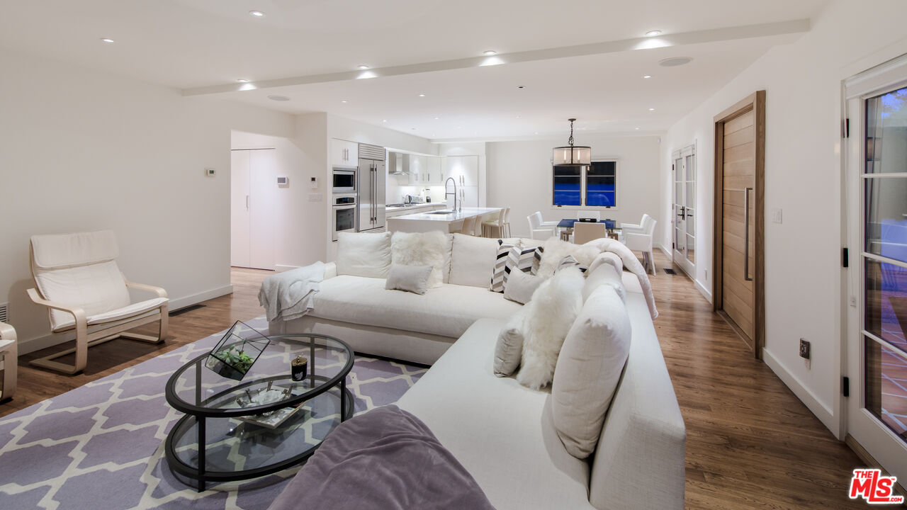 441 North Kings Road Los Angeles, CA 90048 - Photo 13 of 36 a living room with furniture a flat screen tv and a floor to ceiling window