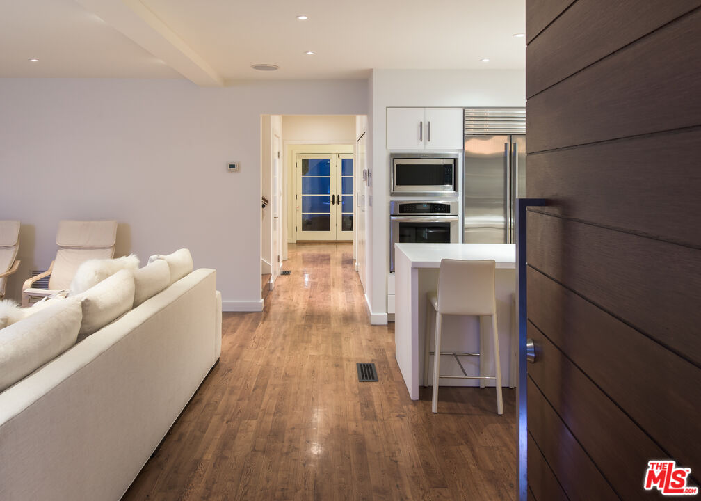 441 North Kings Road Los Angeles, CA 90048 - Photo 2 of 36 a living room with furniture wooden floor and a fireplace