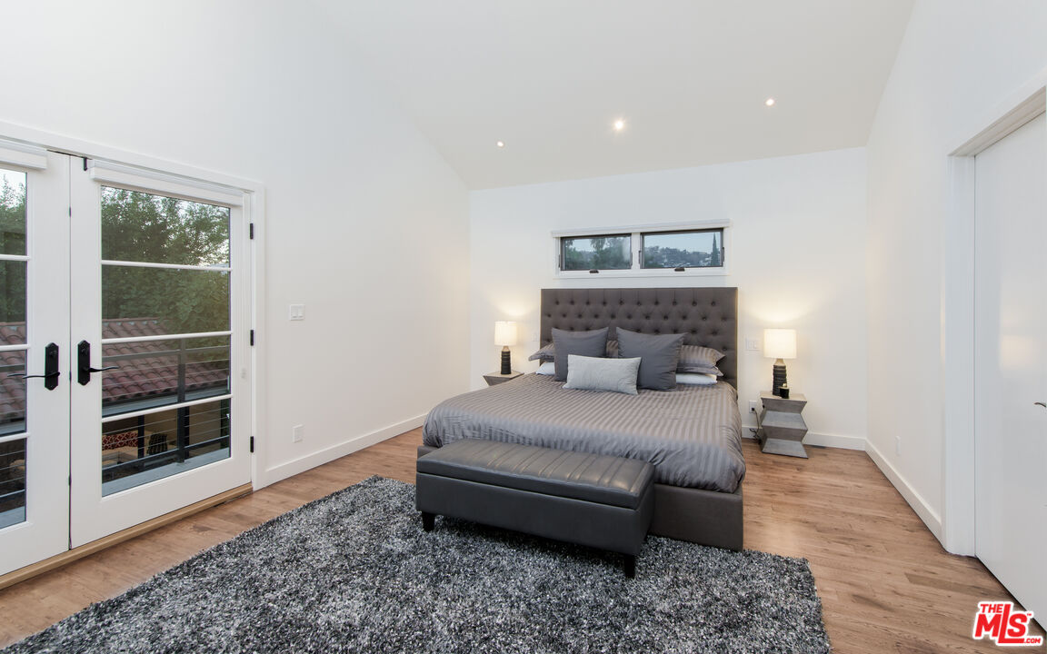 441 North Kings Road Los Angeles, CA 90048 - Photo 23 of 36 a bedroom with a bed and wooden floor