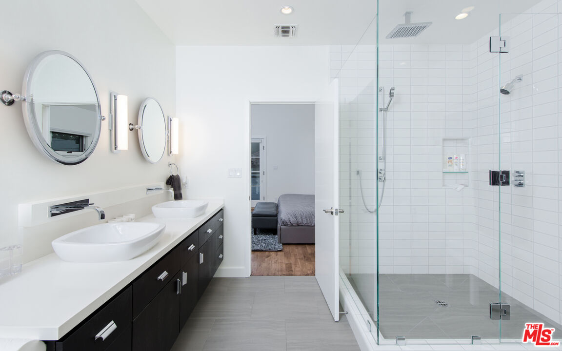 441 North Kings Road Los Angeles, CA 90048 - Photo 25 of 36 a bathroom with a double vanity sink mirror and shower