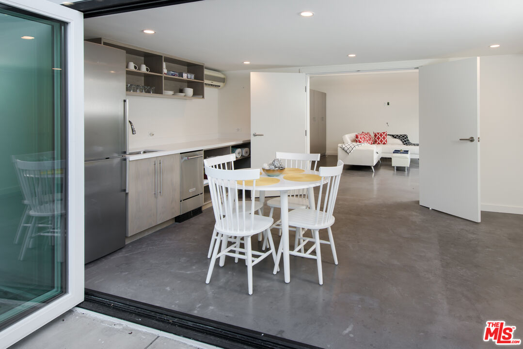 441 North Kings Road Los Angeles, CA 90048 - Photo 34 of 36 a dining room with furniture and a chandelier