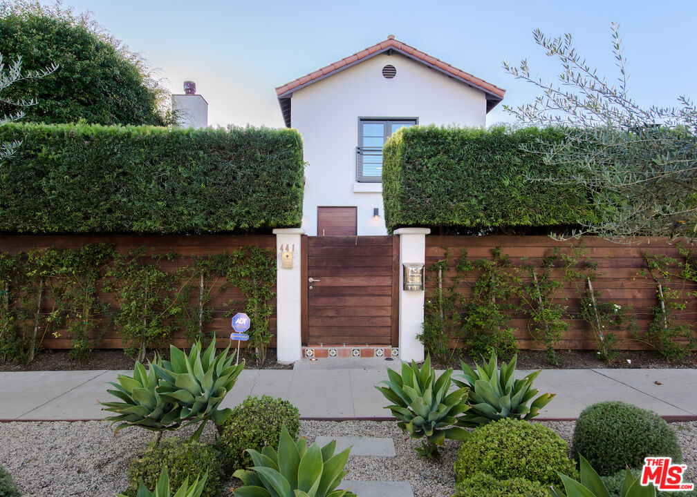 441 North Kings Road Los Angeles, CA 90048 - Photo 6 of 36 a front view of a house with garden