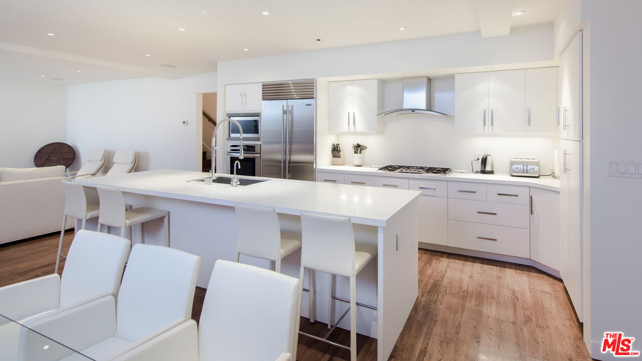 441 North Kings Road Los Angeles, CA 90048 - Photo 10 of 36 a kitchen with stainless steel appliances a stove a sink dishwasher and a refrigerator