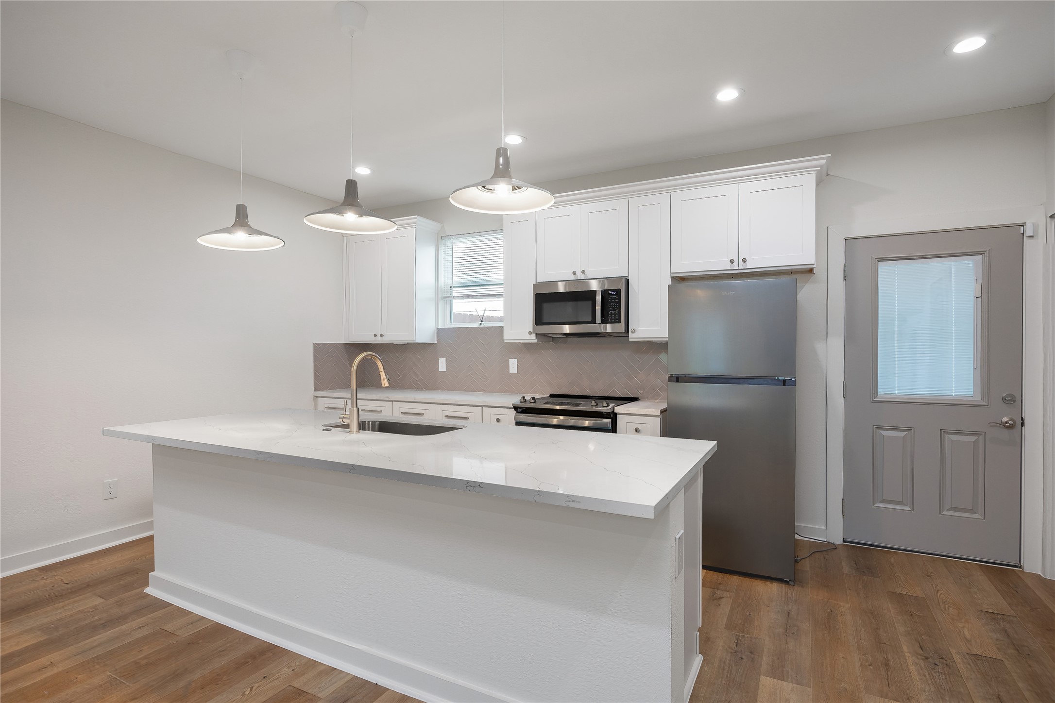 2753 Redrock Street, Unit B Houston, TX 77088 - Photo 13 of 35 a kitchen with kitchen island a sink stainless steel appliances and cabinets