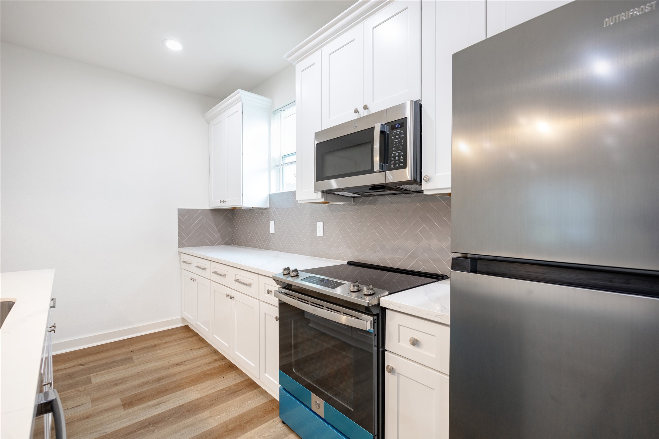 2753 Redrock Street, Unit B Houston, TX 77088 - Photo 17 of 35 a kitchen with granite countertop cabinets stainless steel appliances and wooden floor