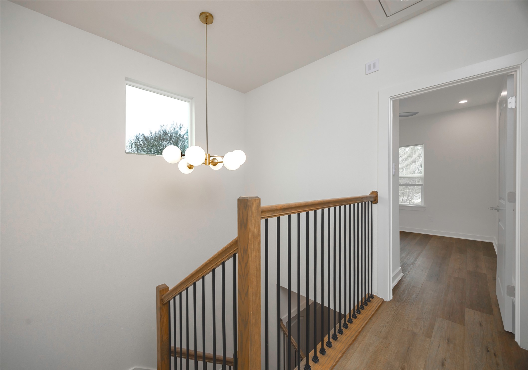 2753 Redrock Street, Unit B Houston, TX 77088 - Photo 22 of 35 a view of a hallway with wooden floor and stairs