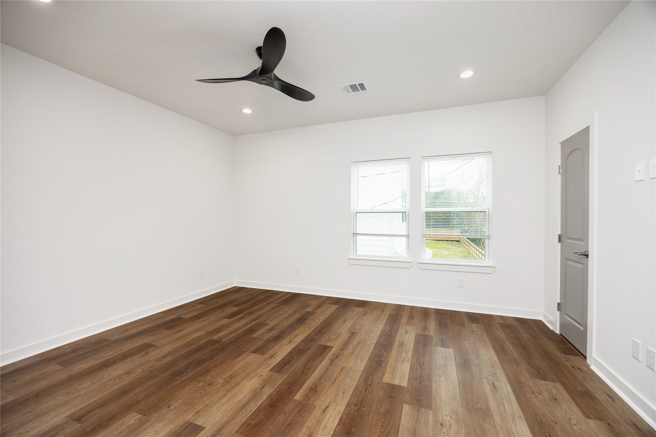 2753 Redrock Street, Unit B Houston, TX 77088 - Photo 23 of 35 a view of empty room with wooden floor and fan