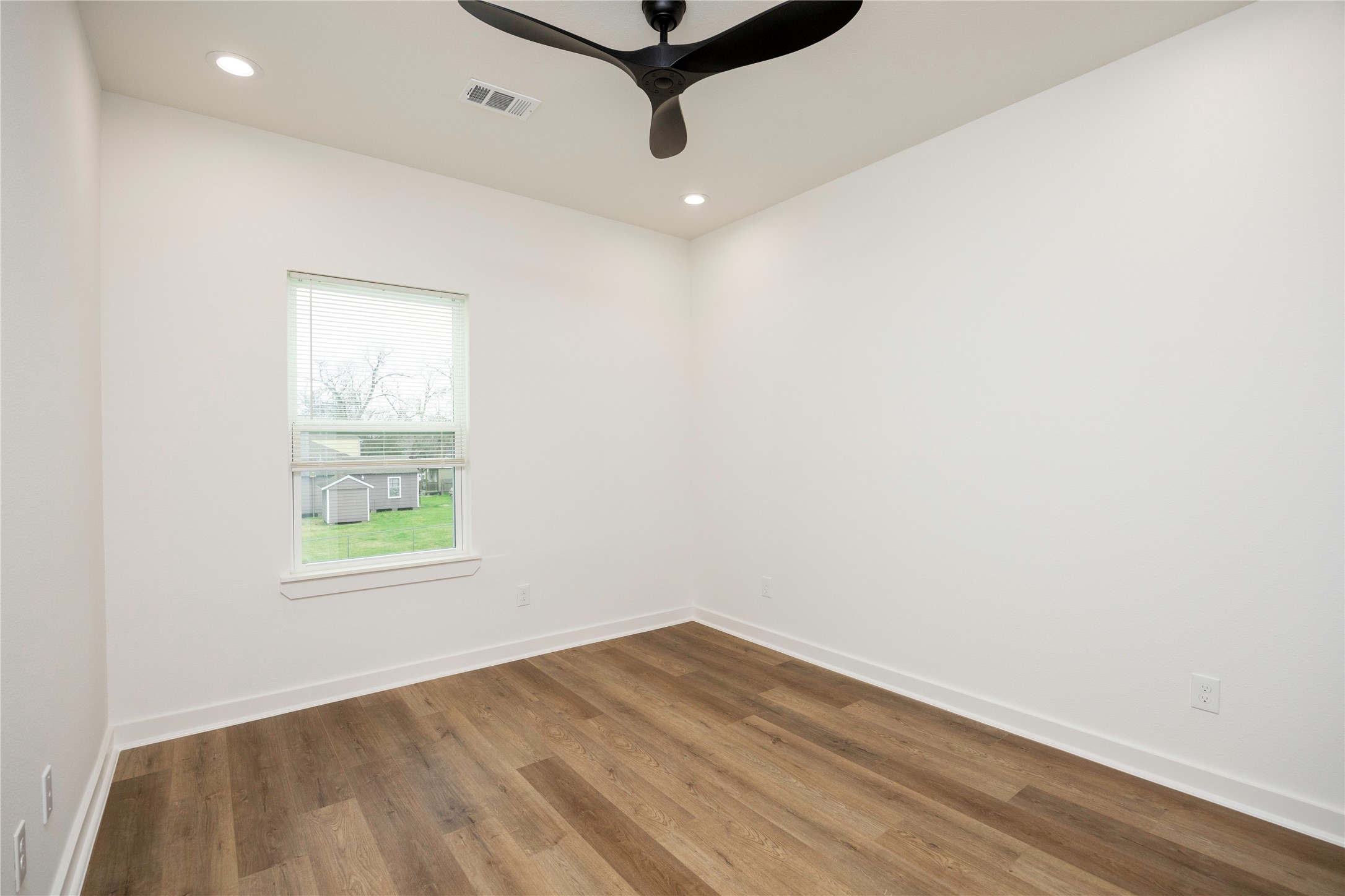 2753 Redrock Street, Unit B Houston, TX 77088 - Photo 29 of 35 an empty room with wooden floor and windows