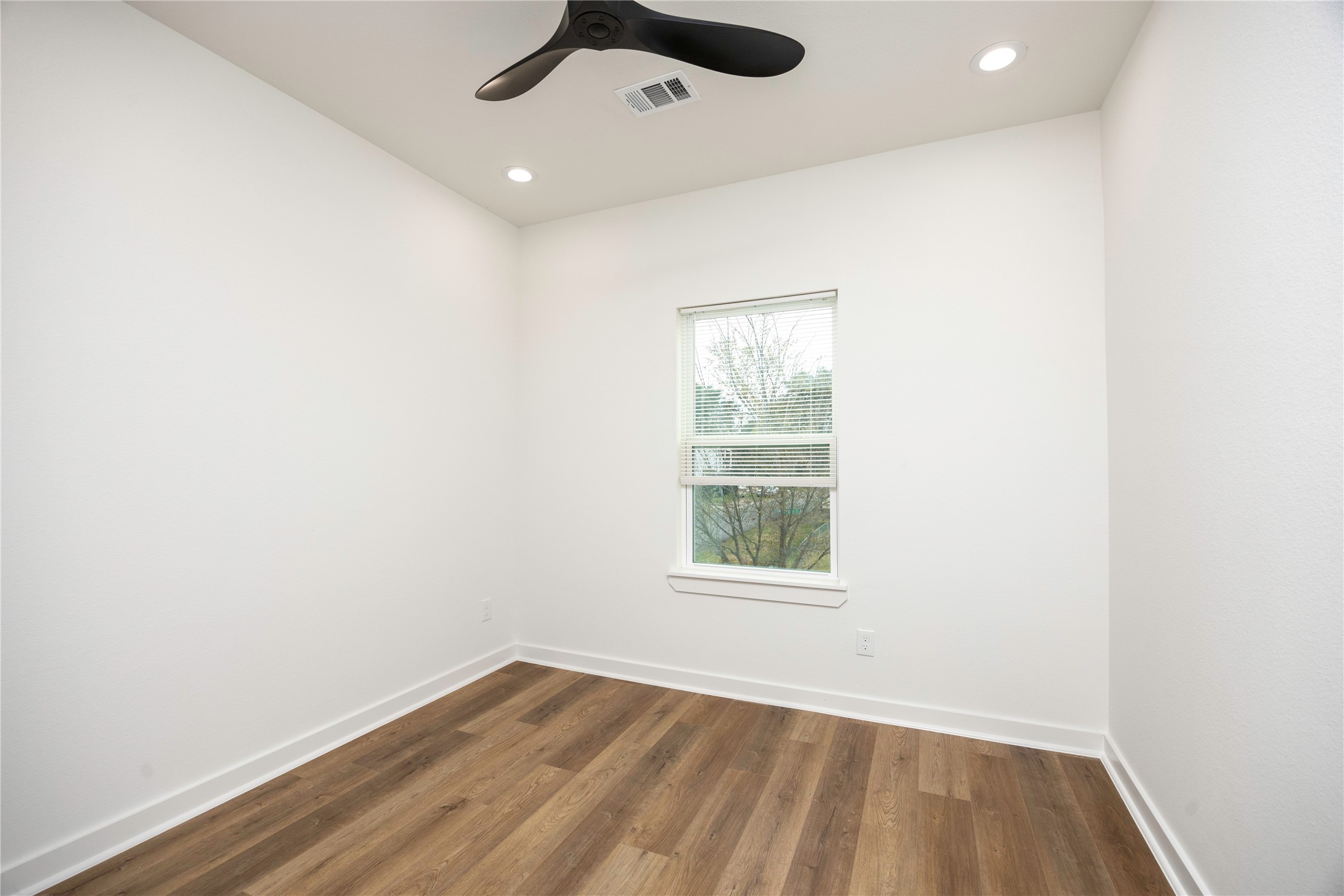 2753 Redrock Street, Unit B Houston, TX 77088 - Photo 33 of 35 an empty room with a window and a ceiling fan
