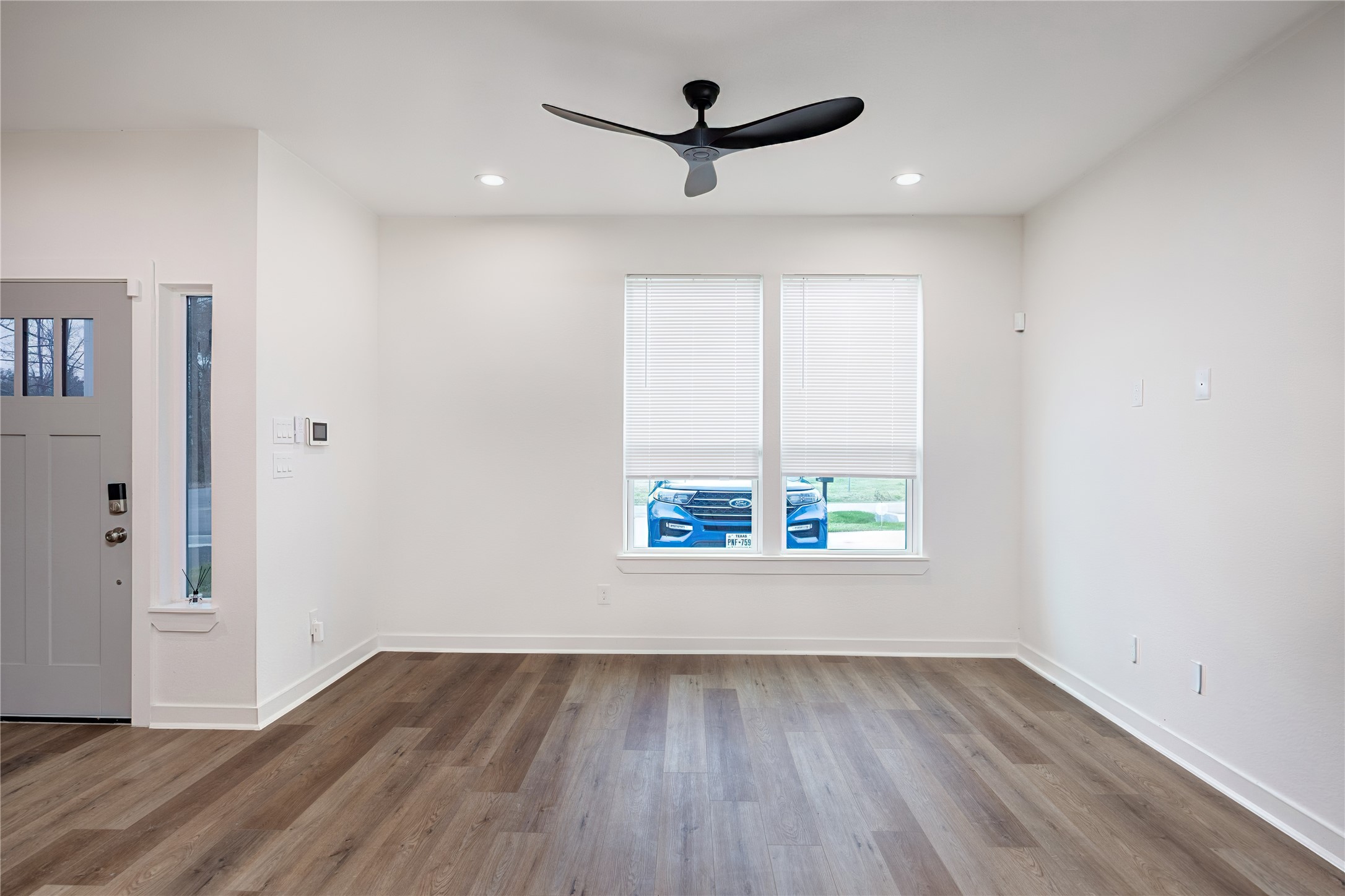 2753 Redrock Street, Unit B Houston, TX 77088 - Photo 9 of 35 an empty room with wooden floor and windows