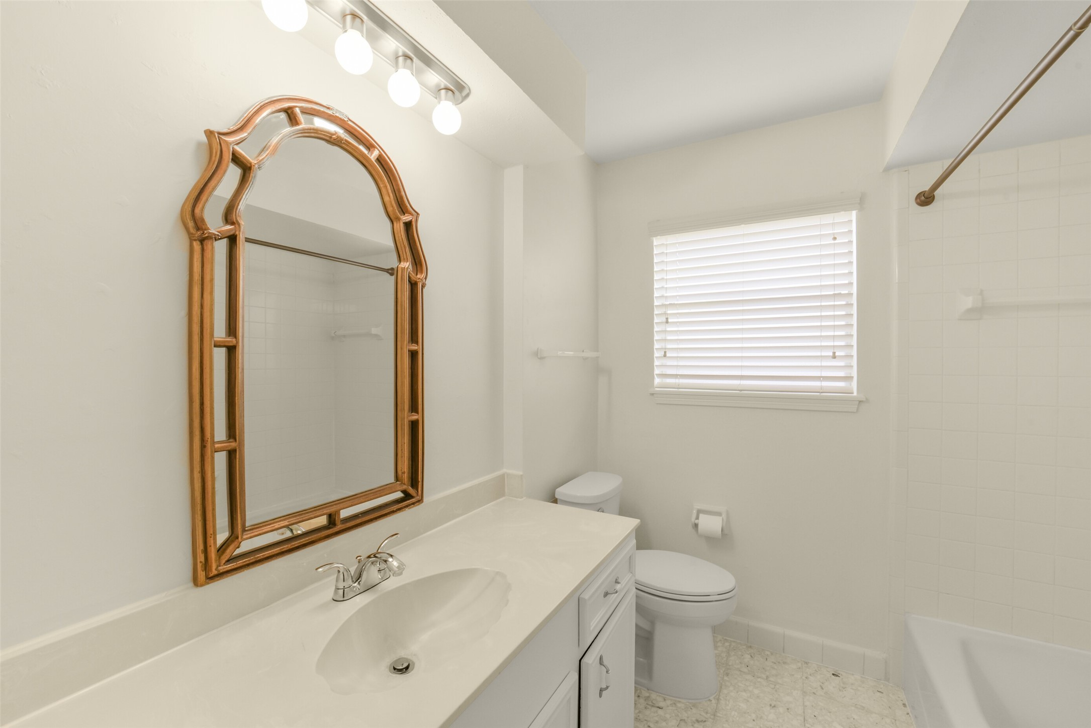 7818 Kleingreen Lane Spring, TX 77379 - Photo 33 of 50 a bathroom with a sink a toilet and mirror
