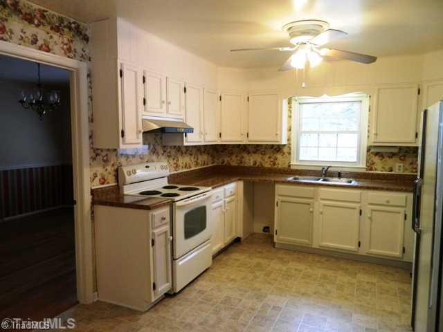 6904 Aplington Road Oak Ridge, NC 27310 - Photo 4 of 14 Kitchen. Good size eat in kitchen with pantry and side door to carport. New vinyl flooring.
