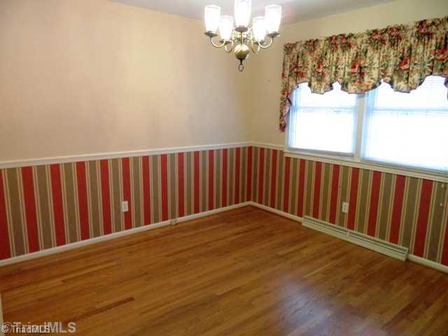 6904 Aplington Road Oak Ridge, NC 27310 - Photo 5 of 14 Dining Room. Dining room has hardwood flooring and located directly off kitchen and living room.