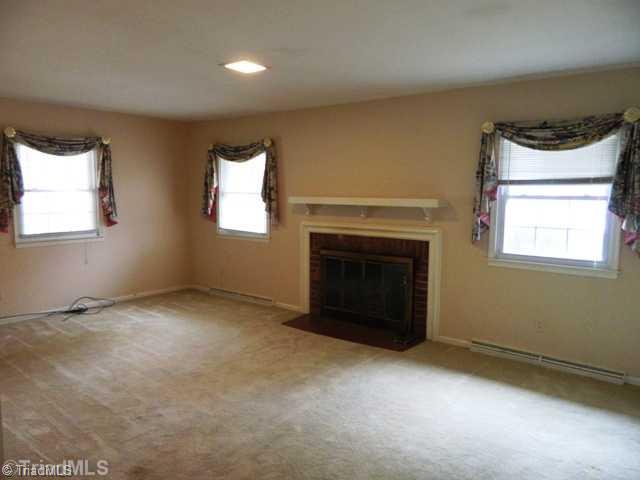 6904 Aplington Road Oak Ridge, NC 27310 - Photo 6 of 14 Living Room. Large Living Room with Wood Burning Fireplace. Smooth ceilings throughout.