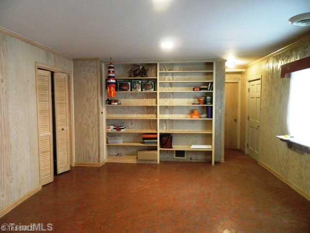 6904 Aplington Road Oak Ridge, NC 27310 - Photo 10 of 14 Other. Finished section of basement with built in shelving. Broken Tile Flooring and closet. Great Office, hobby room, exercise or whatever!
