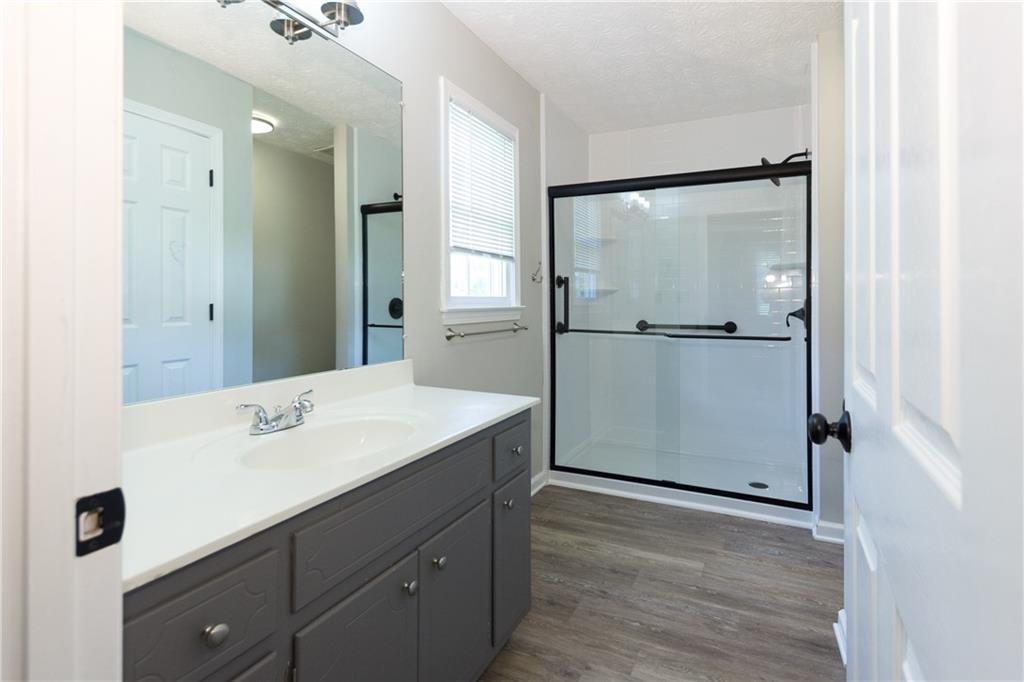 374 McGiboney Road Covington, GA 30016 - Photo 21 of 29 a bathroom with a shower sink and mirror