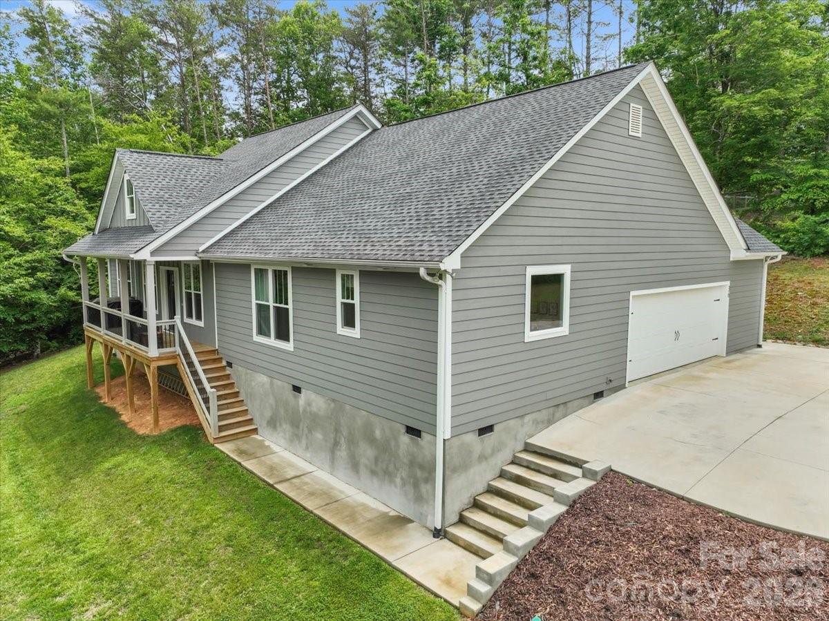 36 Cherry Ridge Lane Weaverville, NC 28787 - Photo 32 of 37 a view of a house with a yard and sitting area