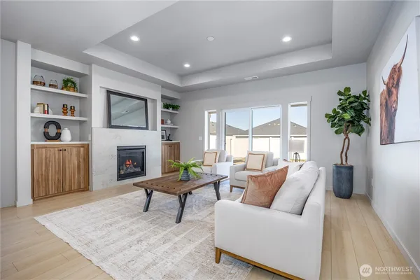a living room with furniture a flat screen tv and a fireplace