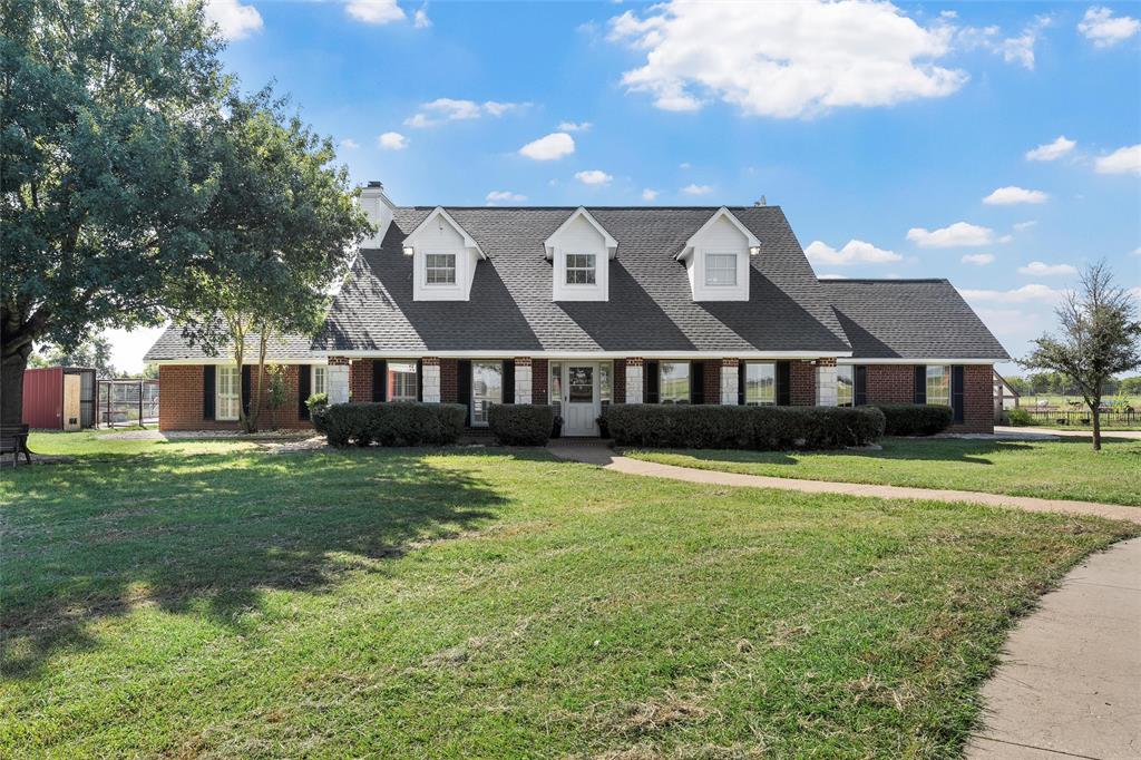 5112 Old Caufield Ranch Road McGregor, TX 76657 - Photo 2 of 38 Cape cod home featuring brick siding, roof with shingles, a front yard, and a chimney