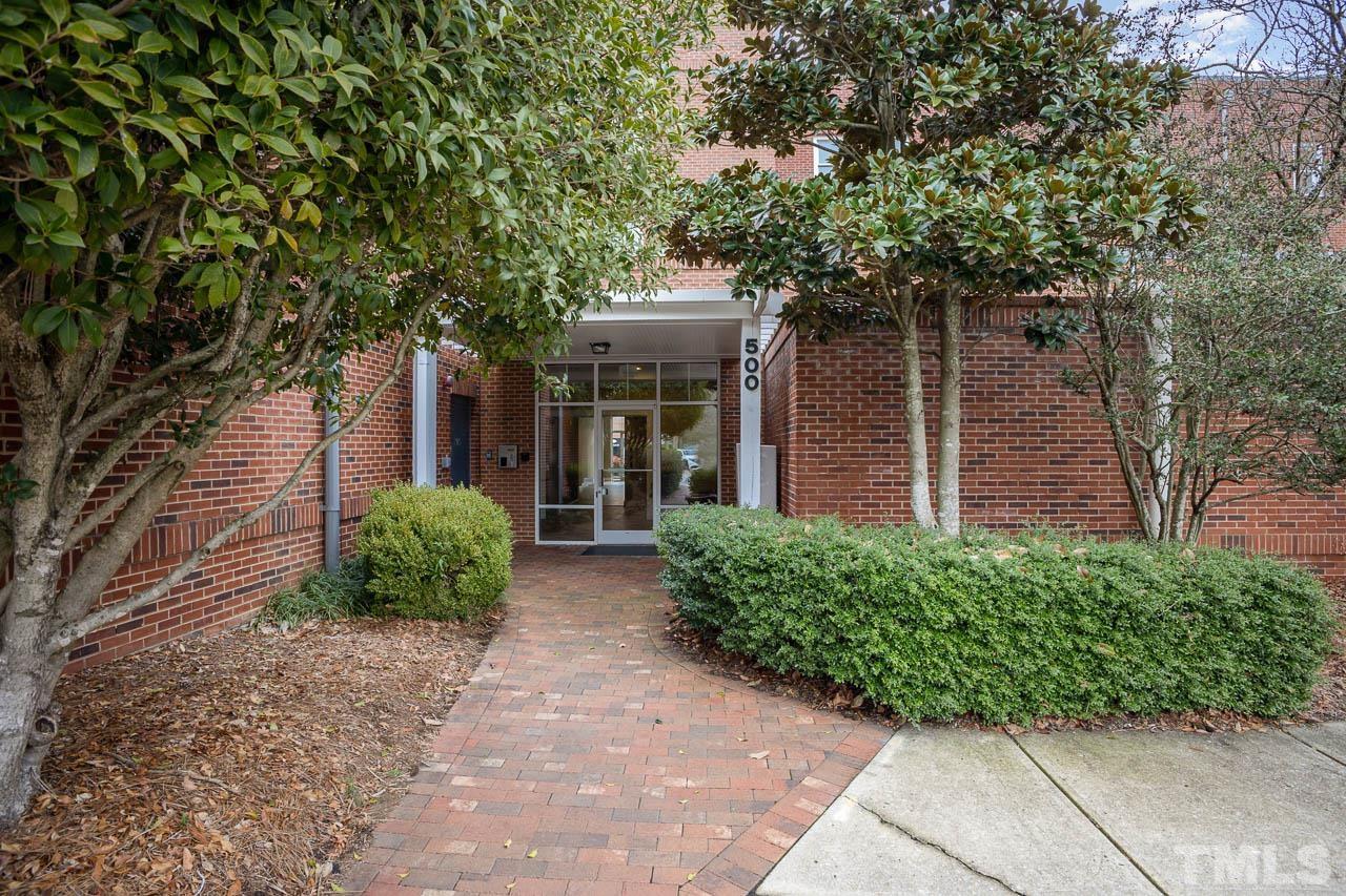 533 Meadowmont Village Circle, Unit XXXX Chapel Hill, NC 27517 - Photo 1 of 25 a front view of a house with a garden
