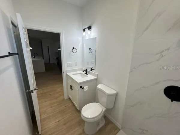 a bathroom with a toilet sink and mirror