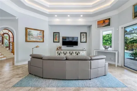 a living room with couches and a flat screen tv